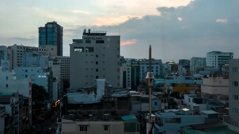 Timelapse view from hotel room as sun sets over Ho Chi Minh City Stock Footage 230014002