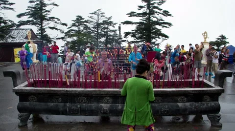 Timelapse view of many pilgrims burning joss sticks  Stock Footage 40754576