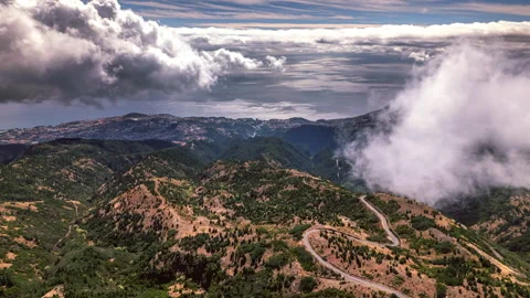 Timelapse with a view over the mountains from cloud height, overlooking a city Stock Footage 301382593
