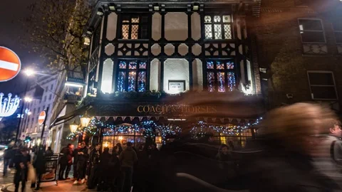 Timelapse view of people drinking and chatting outside a pub in london at night Stock Footage 104126604
