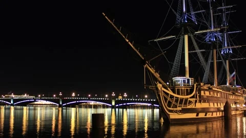 Timelapse view to the river bridge with an old ship night lights background Stock Footage 130178303