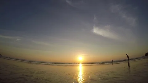 Timelapse view: sea sunset on low water, people silhouette on the beach Stock Footage 71983241