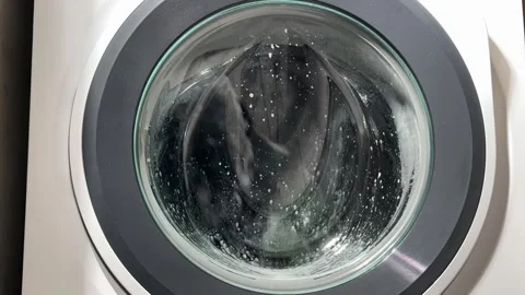 A timelapse view shows water, foam, and detergent swirling inside the washi.. Stock Footage 323118982