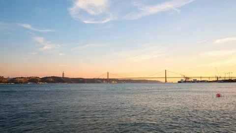 Timelapse view of suspension bridge 25 de Abril on river Tagus at sunset time Stock Footage 103410515
