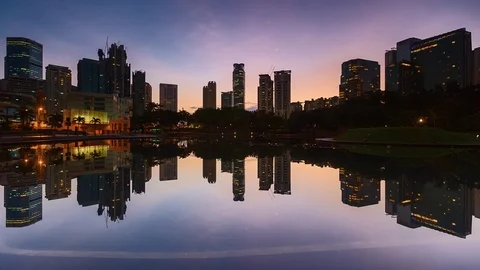 Timelapse view of the symphony lake in KLCC during cloudy sunrise with city b Stock Footage 88200155