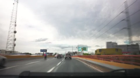Timelapse view through the windshield of a fast driving car in cloudy weather Stock Footage 246491598