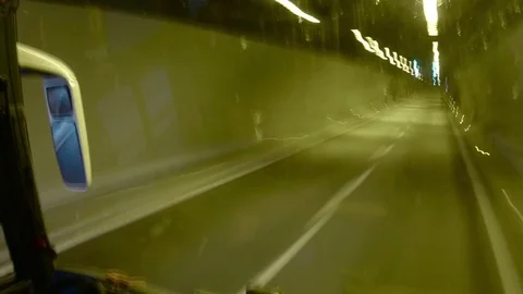 Timelapse view through the windshield of a truck passing through a tunnel lit Video stock 71757680