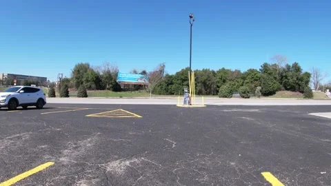 Timelapse view of traffic from a parking lot with clear blue sky Stock Footage 149073811