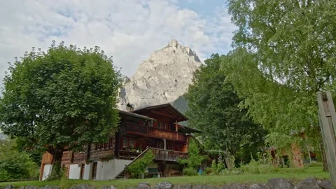Timelapse view on typical swiss house with mountain at the background. Kander Video stock 144451917
