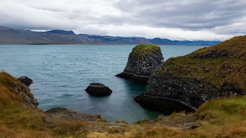 Timelapse view of volcanic basalt formations by a fjord in West Iceland Stock Footage 116182393