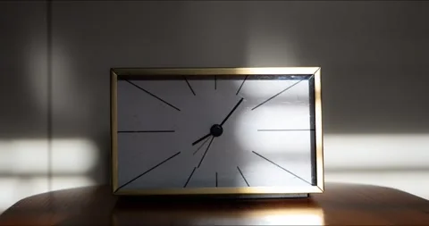 Timelapse of vintage gold table clock with moving shadow and sunlight Stock Footage 341854260
