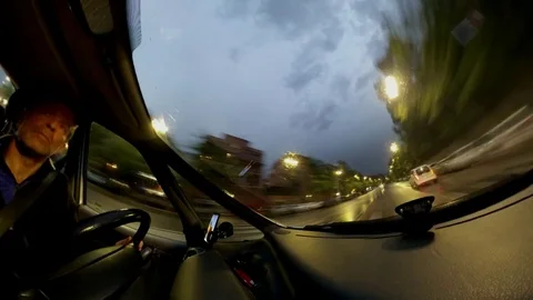 Timelapse vr360  effect A man drivies a car in a city at dusk with rain Stock Footage 108110827