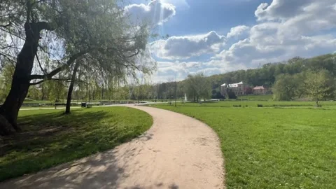 A timelapse of a walk along a path in a park on a sunny spring day. Stock Footage 239638942