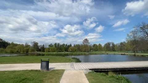 A timelapse of a walk along a path in a park on a sunny spring day. Stock Footage 239638969