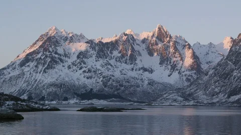 Timelapse of water surface rippling in lake sitting underneath tall mountains Stock Footage 124237746