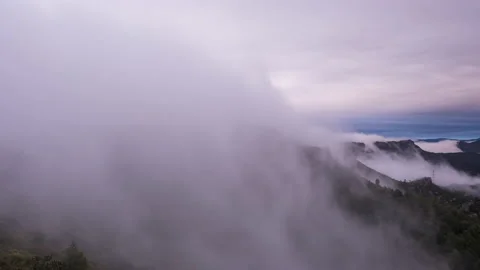 Timelapse of a waterfall of clouds coming down in a wind farm at sunset Video stock 146205989