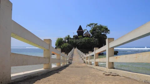 TIMELAPSE Wave Rushing to the Shore, Bridge to Amarta Pura Jati Temple Stock Footage 128911894