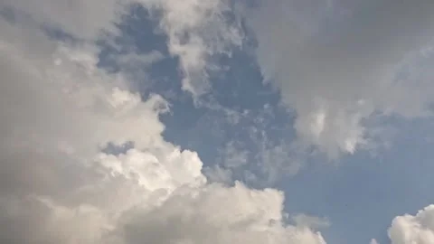 Timelapse of white and gray clouds rolling in the blue sky Stock Footage 320936327