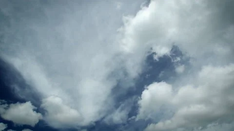 Timelapse of white clouds on a dark blue sky moving in two directions - 4k Stock Footage 50768345