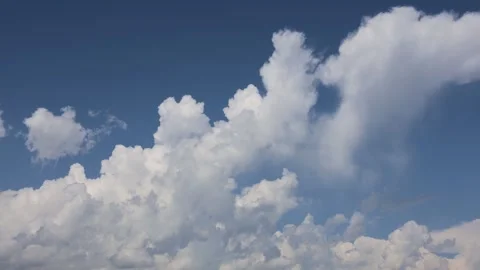 Timelapse of White Clouds Drifting Across a Clear Blue Sky Stock Footage 344734905