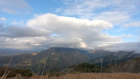 TimeLapse white clouds float across the sky over a mountain lake 動画素材 119531133