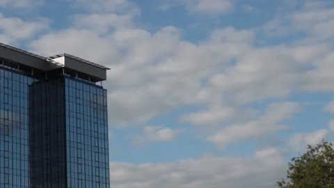 Timelapse, white clouds fly above a tall building Stock Footage 131951372