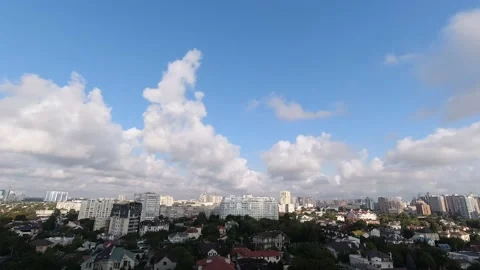 Timelapse with white clouds flying fast over the city on a sunny bright summer Stock Footage 141497691
