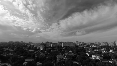 Timelapse with white clouds flying fast over the city on a sunny bright summer Stock Footage 141649616