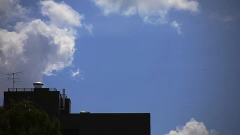 Timelapse white clouds move across the blue sky Video stock 113328533