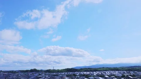 Timelapse of white clouds moving across the bright blue sky over Fukuoka Vídeos de archivo 336251473