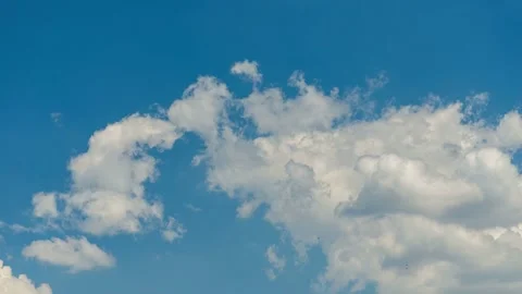 Timelapse of white clouds moving fast across blue sky Stock Footage 337609698
