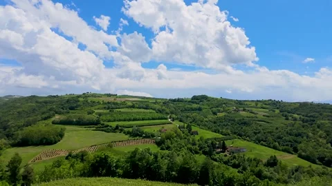 Timelapse of White Clouds Moving Over Green Rolling Hills in Piedmont Italy Stock Footage 335612168