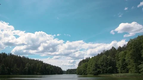 Timelapse of white clouds over the lake in good summer weather Stock Footage 133939833