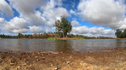 Timelapse of white clouds over the lake in good summer weather Stock Footage 137791052