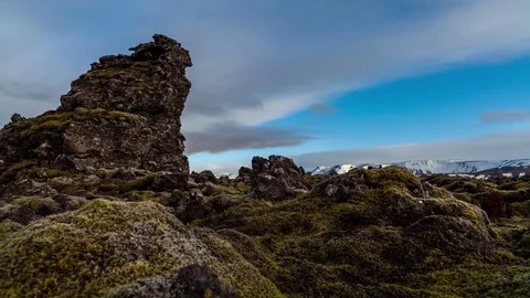 Timelapse of white clouds rolling over mossy lava field Video stock 73011073