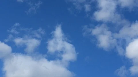 Timelapse of white clouds running on a blue sunny sky. Stock Footage