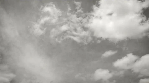 Timelapse of white clouds running in two directions - black and white - 4k Stock Footage 50768998