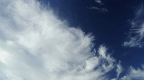 Timelapse of white clouds under a dark blue sky. Cirrus and cirrostratus. Stock Footage 68343110