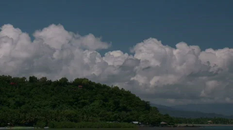 Timelapse of White Cumulus Clouds forming over tropical coast Stock-Footage 556839