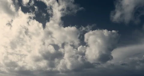 Timelapse of white cumulus obscuring the sky. Blue and yellowish 4K footage. Stock Footage 150564166