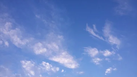 Timelapse - White gentle clouds passing in the blue sky on a sunny morning Stock Footage 74491014