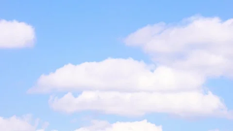 Timelapse of white puffy clouds with blue sky in background. Ultra HD footage 4k Video stock 115654347