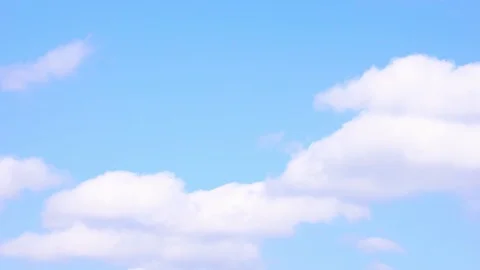Timelapse of white puffy clouds with blue sky in background. Ultra HD footage 4k Stock Footage 115654447