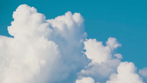Timelapse of white puffy cumulus clouds forming on summer blue sky. Moving and Video stock 234485466