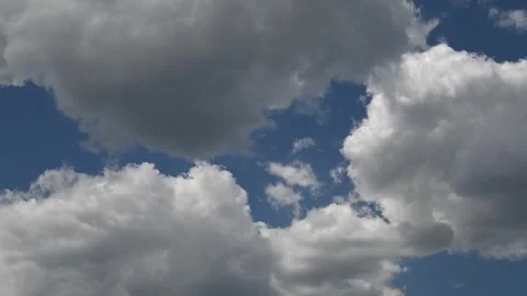 Timelapse of White Summer Clouds Billowing Across a Bright Blue Sky on a Clear Stock Footage 331683860