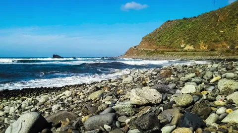 Timelapse of wild stone beach on coast or shore of ocean Stock Footage 49665941