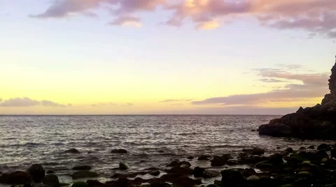 Timelapse of wild stone beach on coast of ocean at sunset Stock Footage 49666009