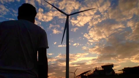 Timelapse of wind turbines spinning in the evening with moving clouds. Stock Footage 163780345