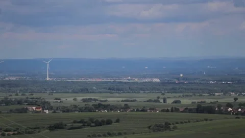 Timelapse of a windmill standing in a vast landscape Stock Footage 208844159