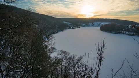 Timelapse of the winter forest landscape on the bank of a frozen river Stock Footage 73497249